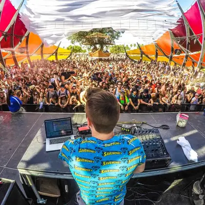 Festival crowd in front of a DJ booth